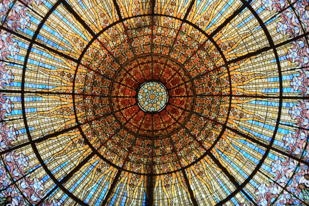 Vibrant stained glass dome in Palau de la Música Catalana, Barcelona, showcasing intricate artistry.
