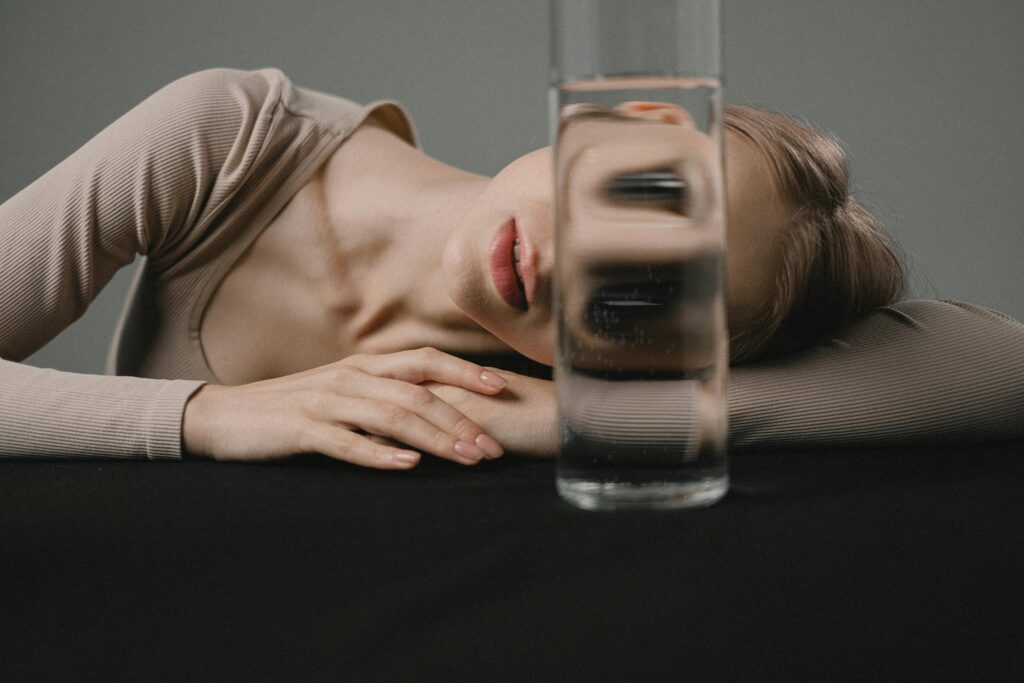 Creative portrait with glass reflection distorting a woman's face
