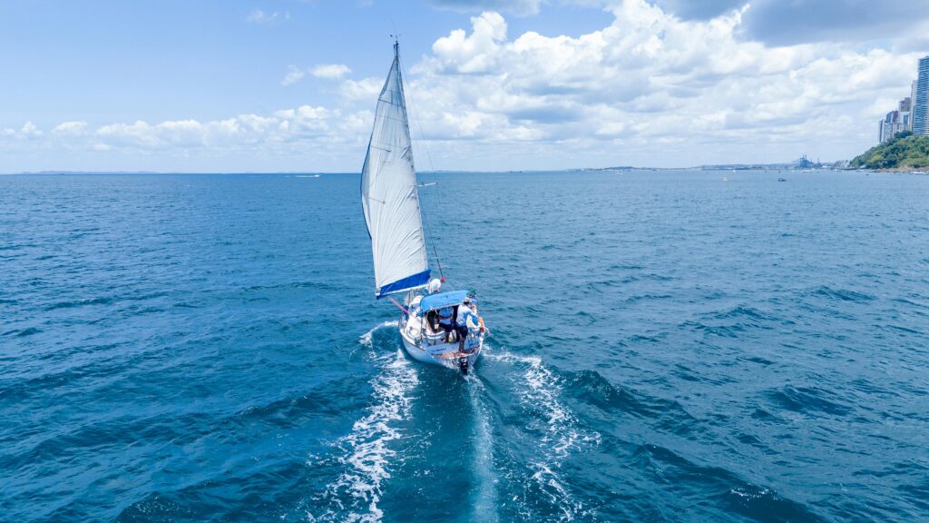 A sailboat gliding through the blue sea near Salvador, Brazil, captures the essence of a nautical adventure.